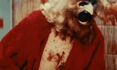 a close up of a bloody santa claus with blood on his shirt