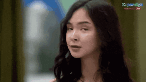 a close up of a woman 's face with the words kapamilya online live on the bottom right