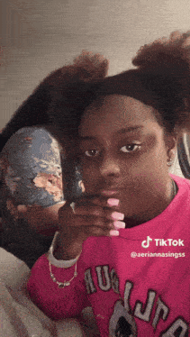 a woman wearing a pink sweatshirt with the word au on it