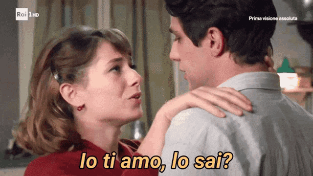 a man and a woman are kissing with the words lo ti amo lo sai