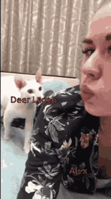 a woman blowing a kiss to a white cat with the words deer ladeh alex written on the bottom
