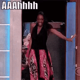 a woman in a red dress is standing in a doorway with a caption that says aaahhhh .