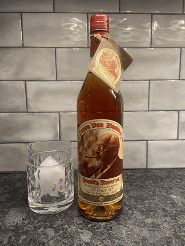 a bottle of jimmy don 's bourbon sits on a counter next to a glass