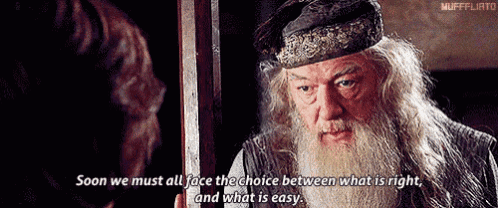a man with a beard and a hat is standing in front of a door and talking to another man .