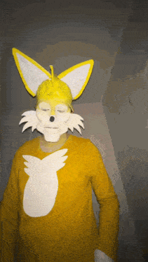 a person wearing a yellow fox costume with a white tail