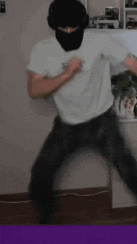 a man wearing a ski mask and headphones is dancing
