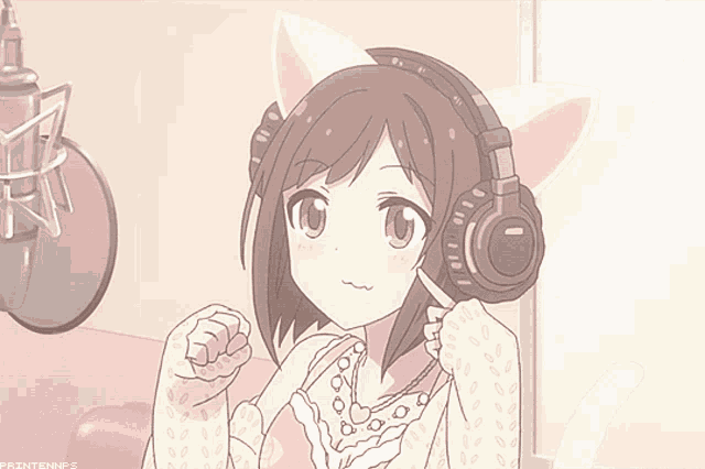 a girl with cat ears is wearing headphones and smiling in front of a microphone