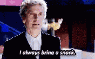 a man in a suit and tie is talking about always bringing a snack .