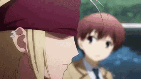 a couple of anime characters are standing next to each other . one of the characters is wearing a red hat .