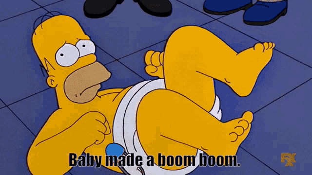 a cartoon of homer simpson laying on the floor with the words baby made a boom boom