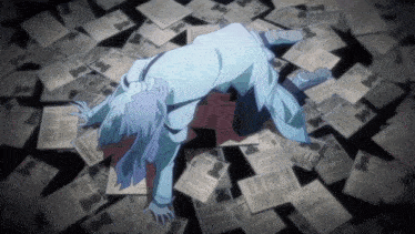 a person is laying on the floor surrounded by papers including one that says ' wanted '