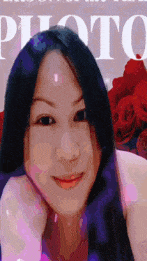 a woman with long black hair is smiling in front of the word photo