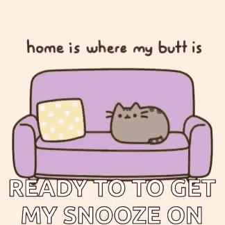 a cartoon cat is laying on a purple couch with a pillow .
