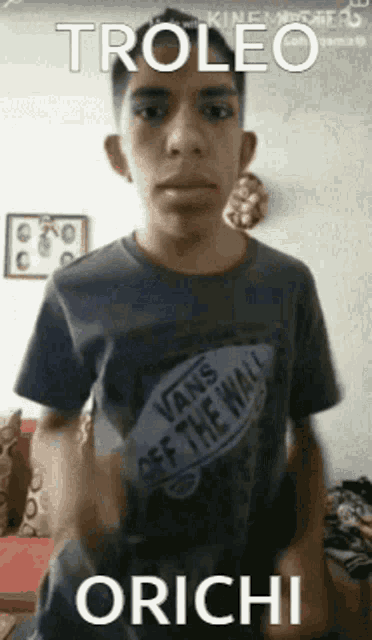 a young man wearing a vans off the wall shirt