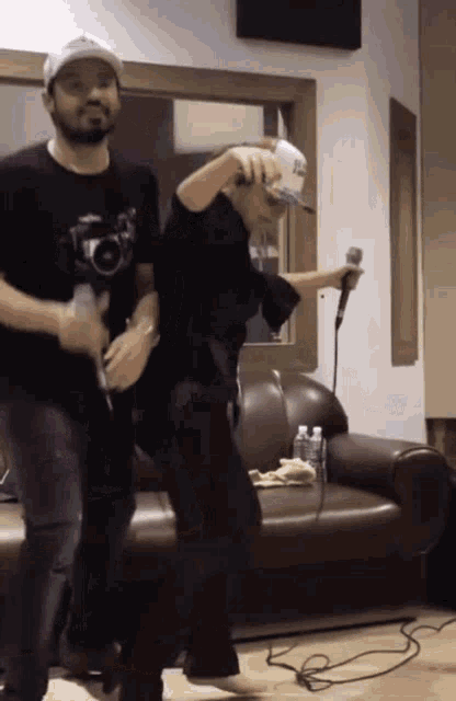 a man and a woman are dancing in a living room