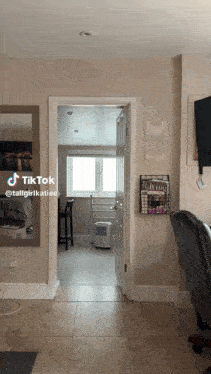 a room with a mirror and a chair with a tiktok written on it