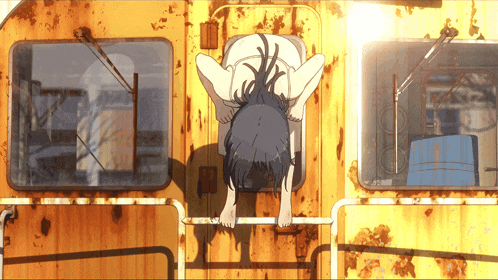 a girl is crawling on the side of a train