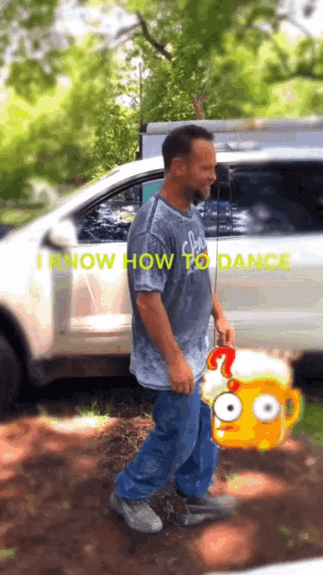a man is standing in front of a car with the words " i know how to dance " on it