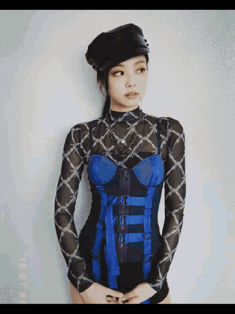 a woman wearing a black hat and a blue corset has a date stamp of 10 01 20