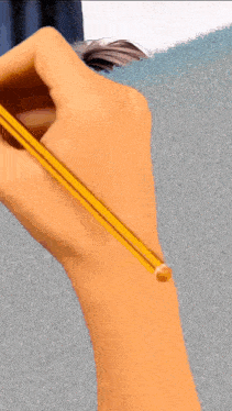 a close up of a person 's hand holding a yellow pencil