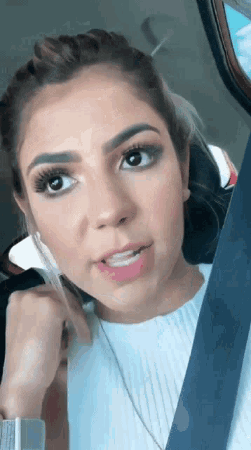 a woman talking on a cell phone in a car seat