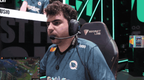 a man wearing headphones sits in a secret lab gaming chair