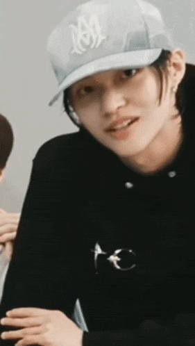 a close up of a person wearing a baseball cap