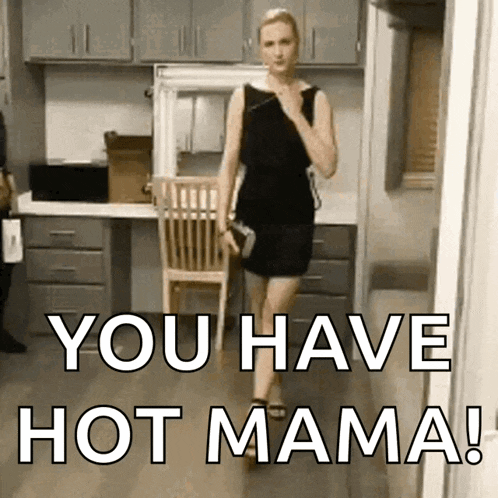 a woman in a black dress is walking down a hallway with the words " you have hot mama " on the bottom