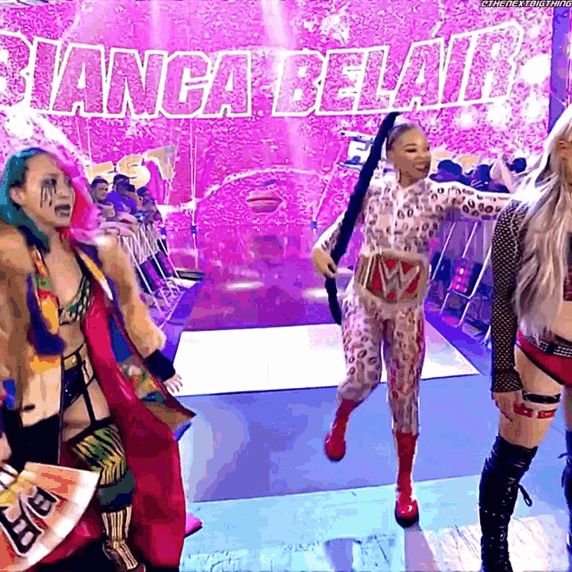 a group of women are standing in front of a sign that says " bianca belair "