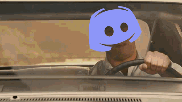 a man driving a car with a blue discord face on his face