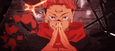 a close up of a person 's face with their hands folded in prayer
