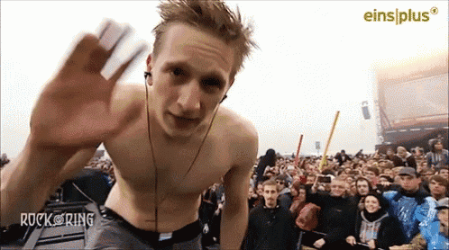 a shirtless man stands in front of a crowd with the words rock ring written on the bottom