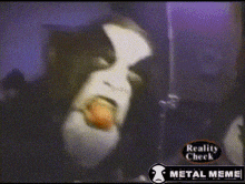 a video of a person with a tongue sticking out and the words reality check metal meme