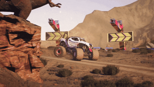 a monster truck driving down a dirt road