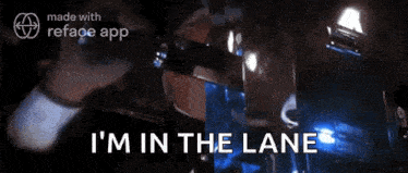 a man in a helmet says i 'm in the lane while standing in front of a building .
