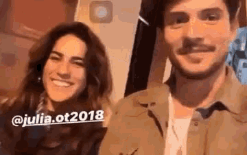 a man and a woman are posing for a picture together and smiling .