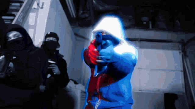 a man in a blue jacket is pointing a gun at the camera