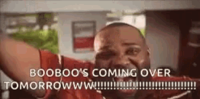 a man in a red shirt is holding his arms in the air and says booboo 's coming over tomorrow .