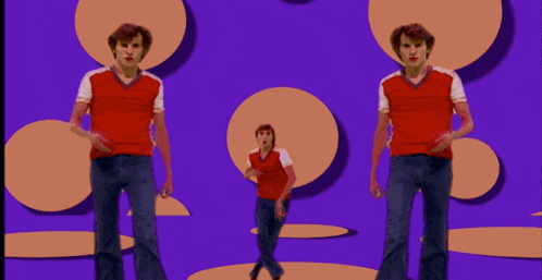 a man in a red shirt blows a kiss