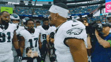 a group of football players including number 17 are standing in a stadium