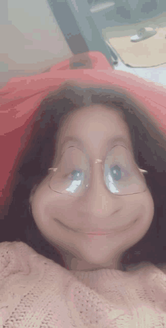 a girl wearing glasses making a funny face