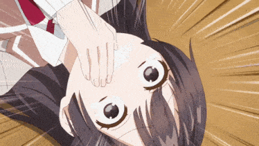 a close up of a girl 's face with her hand on it