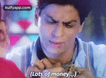 a man is holding a woman 's hand and talking about money .