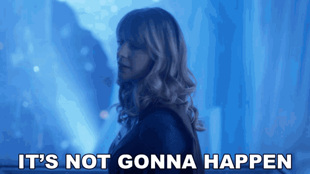 a woman is standing in front of a blue background with the words it 's not gonna happen