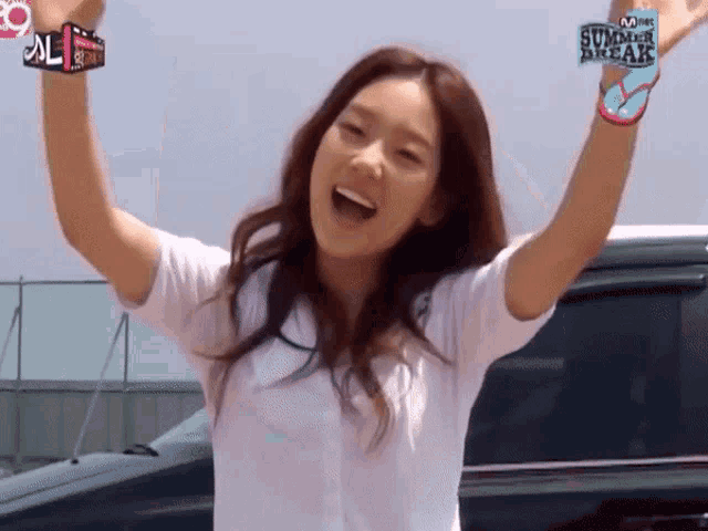 a woman with her arms in the air and a watch that says summer break on it