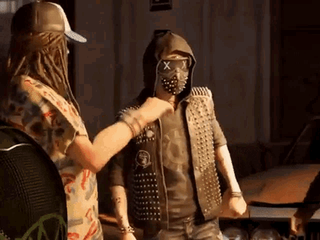 a man wearing a mask and a studded vest is standing next to a woman .