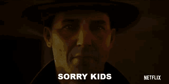 a man in a cowboy hat is looking at the camera and says sorry kids .