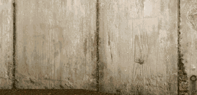 a close up of a wooden fence with a few holes in it