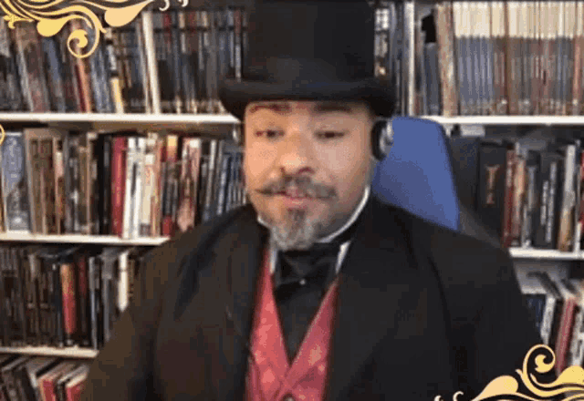 a man wearing a top hat and headphones in front of bookshelves