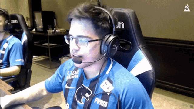 a man wearing headphones and a shirt that says ' ea ' on it